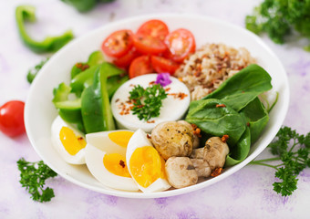 Diet menu. Healthy lifestyle. Oatmeal porridge, egg and fresh vegetables - tomatoes, spinach, paprika,  mushrooms and yogurt  on plate.