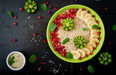 Tasty and healthy oatmeal porridge with fruit, berry and flax seeds. Healthy breakfast. Fitness food. Proper nutrition. Flat lay. Top view