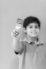 Portrait of a happy young boy painter