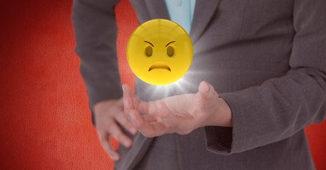 Close up of woman's hand with emoji and flare against red wall