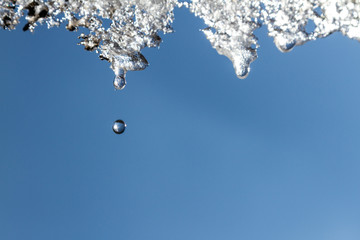 Icicles on the sky background