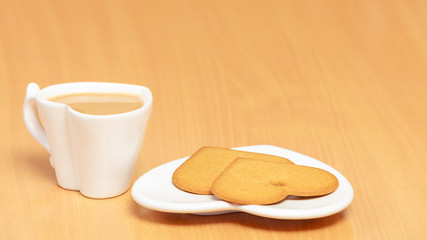 Gingerbread cookies and tea coffee on table.