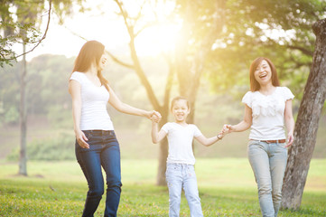 Fototapeta premium Asian family playing outdoors