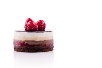 Sweet and tasty chocolate cake with the raspberry on the white background.