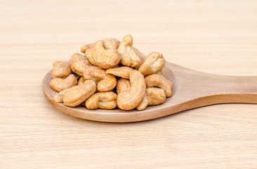 cashew nuts with salt on wood table