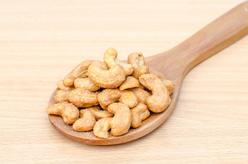 cashew nuts with salt on wood table