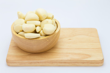 Fresh nutrition garlic on wooden bowl, on white background