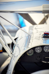 Fototapeta premium The tail of a sports aircraft in a hangar on the service.