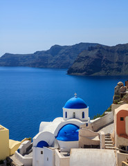 White church with blue dome in Santorini, Greece