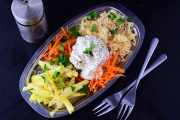 Fresh salad with celery, apple, carrot with yogurt on a metal plate on a grey background. Healthy eating concept. Dieting