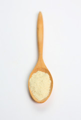 Full Powdered milk in wooden spoon over white background