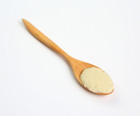 Cereal in wooden spoon over white background