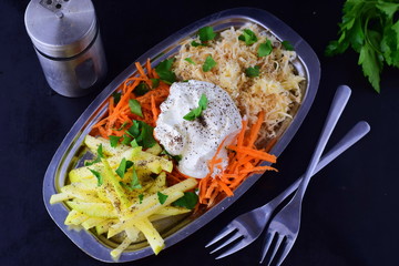 Fresh salad with celery, apple, carrot with yogurt on a metal plate on a grey background. Healthy eating concept. Dieting