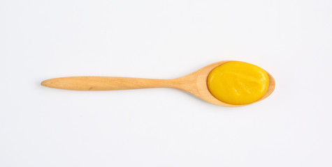 Vegetarian pumpkin soup in wooden spoon over white background