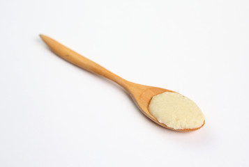 Cereal in wooden spoon over white background