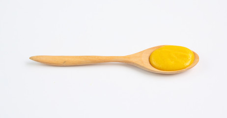 Vegetarian pumpkin soup in wooden spoon over white background