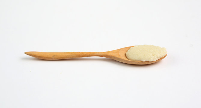 Cereal in wooden spoon over white background
