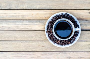Coffee cup with coffee bean on wooden table view from top
