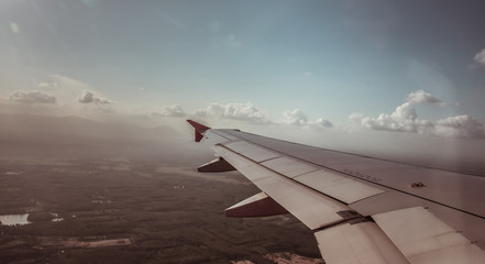 Fototapeta na wymiar Cloudy Airplane Wing.