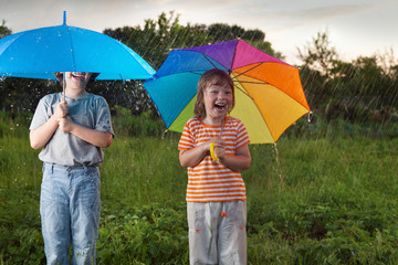happy brother with umbrella outdoors