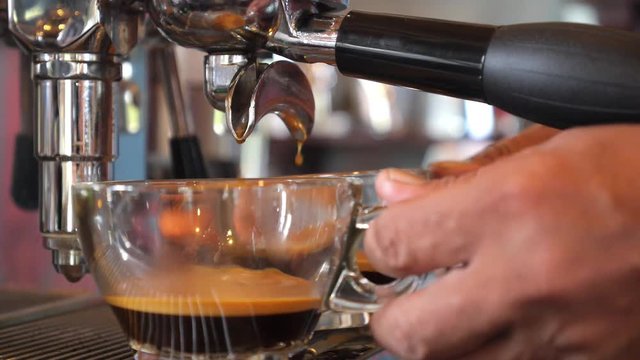 Close-Up of Espresso Pouring from Coffee Machine. Professional Coffee Brewing