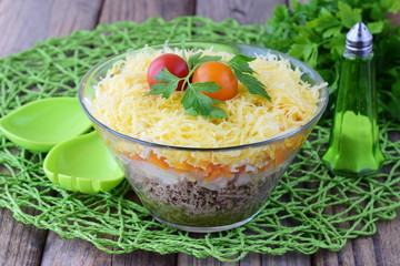 Salad with chicken liver in layers with pickles,boiled carrot, egg, cheese in a glass bowl on a black abstract background. Top view. Healthy food concept