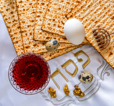 Traditional food and drinks - matzo, egg, and wine for Jewish Passover - (three Hebrew letters mean - pesah - or Passover 