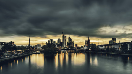 Fototapeta na wymiar Frankfurt skyline at dusk under stormy skies