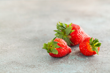 Strawberry. Fresh strawberry on dark background . Red strawberry. Loosely laid strawberries in different positions. Copyspace.