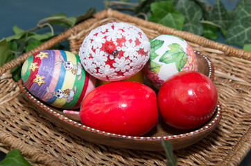 Colorful easter eggs in a ceramic bowl.