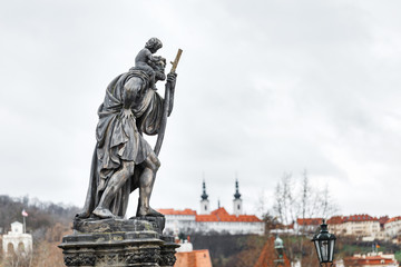 Fototapeta premium Statue of Child Christus at the shoulder of saint Christopher, Patron of wanderers, navigators and travelers on Charles Bridge, Prague