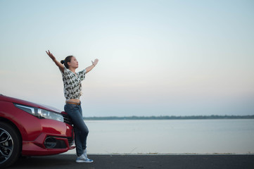young woman happy and car red