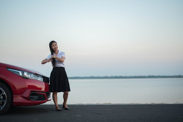 young woman happy and car red