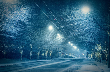 snowy road at night in downtown in winter season.   © checubus