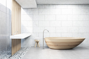 Fototapeta na wymiar Gray brick bathroom, wooden tub, front