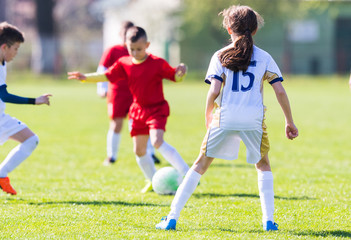 Obraz premium Kids soccer football - children players match on soccer field