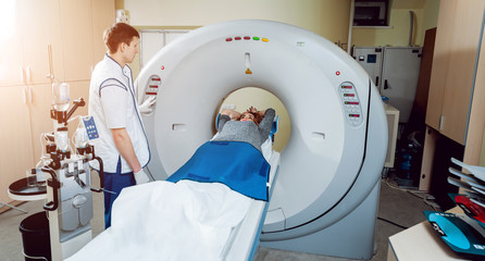 Medical equipment. Doctor and patient in the room of computed tomography
