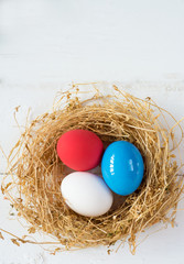 Bright colored dyed eggs on wooden