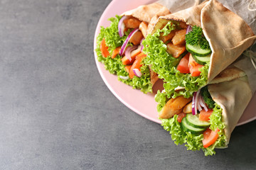 Plate with tasty kebab sandwiches on grey table
