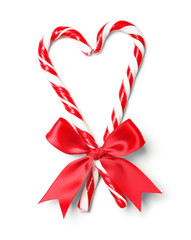 Heart shape made with candy canes on white background