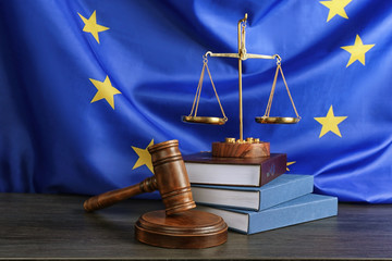 Judge gavel and books with scales on European Union flag background