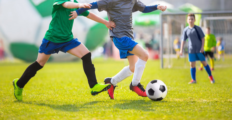 Obraz premium Football match for children. Training and football soccer tournament. Children kicking soccer training match. Young boys competing for the ball