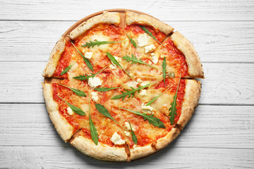 Delicious pizza on wooden table, top view