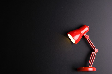 Red lamp isolated on black background with copy space image for your text.