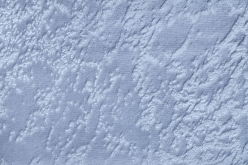 Obraz premium Light blue background from a soft upholstery textile material, closeup.