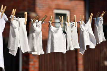 
Vintage underclothing hanging to dry pinned to a line with old style clothespins 