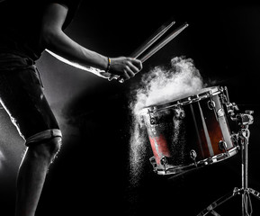 man plays musical percussion instrument with sticks, a musical concept, beautiful lighting on the...