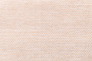 Light beige textile background closeup. Structure of the fabric macro