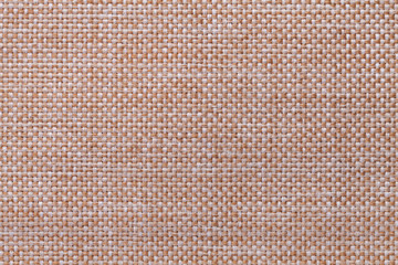 Fototapeta premium Light brown textile background closeup. Structure of the fabric macro