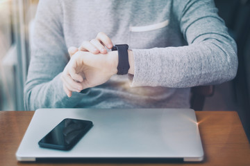 Man working in a cafe on sunny day